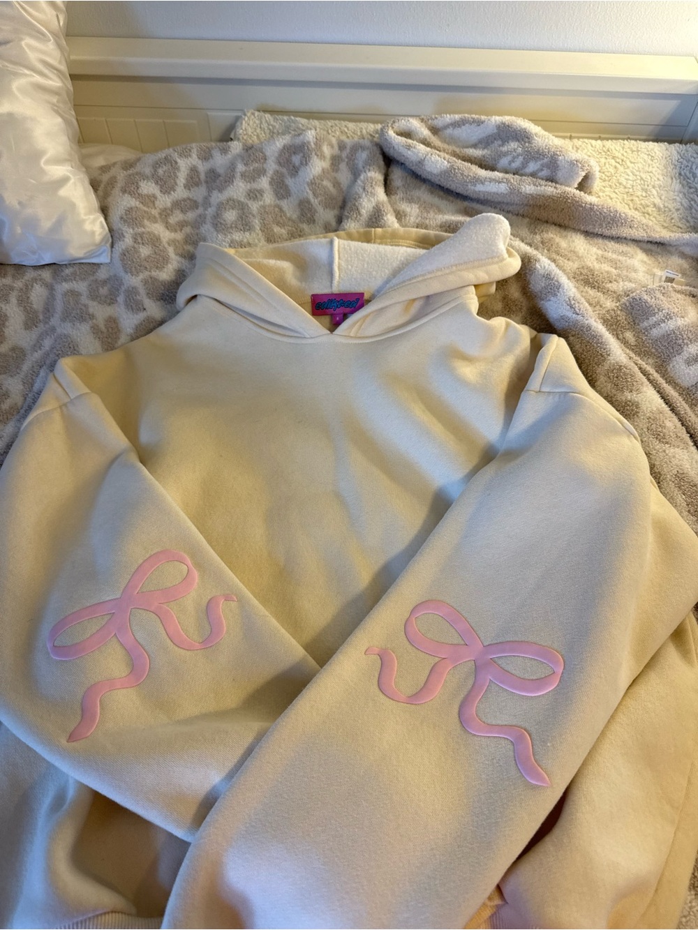 Edikted Cream Hoodie with Pink Bow Sleeve Appliqués